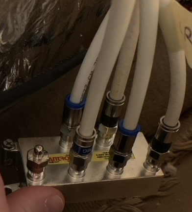 Six port MoCA splitter showing five coaxial cables and one terminator connected to the outputs.